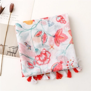 Detail of floral printed scarf with tassels featuring watercolor pomegranate patterns