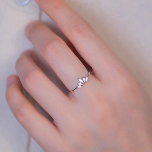 Close-up of s925 silver princess crown ring with marquise cut cubic zirconia on a finger