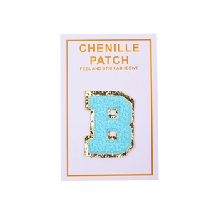 Detail of blue chenille letter B patch with gold glitter edge and peel and stick adhesive