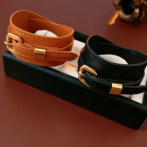 Faux leather double wrap bracelets in black and brown with golden metal buckle