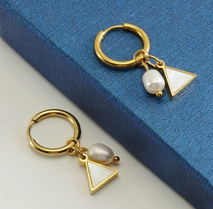 Detail of 18K gold geometric earrings featuring natural pearls and triangular shell drops