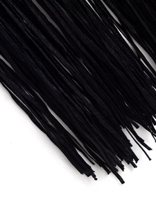 Detailed close-up showing the high-quality black tassel fringe hem on a sleeveless dress