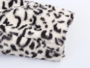 Detailed close-up of high-quality leopard print faux fur texture on a winter coat fabric