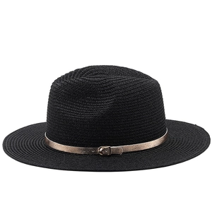 Detail of black straw fedora hat featuring a stylish rose gold faux leather belt buckle