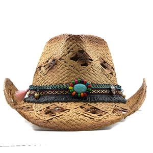 Detail of straw cowboy hat featuring hollow diamond patterns and turquoise bead tassel decor