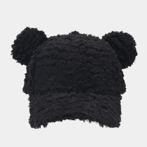 Detailed texture of black plush baseball cap with cute fluffy faux fur bear ears