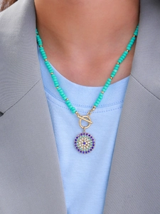 Detail of 14K gold plated necklace with turquoise beads and a crystal toggle clasp