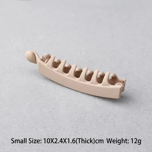 Detail view of small beige matte banana hair clip showing 10x2.4x1.6cm dimensions