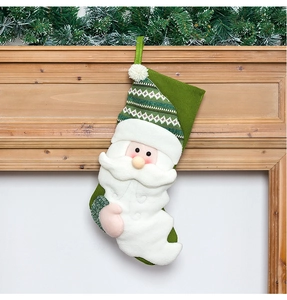 Close-up of a green knitted Christmas stocking with Santa Claus decor on wooden mantel