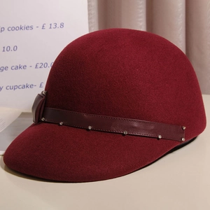 Detail of burgundy wool equestrian hat with leather band and sparkling rhinestone studs