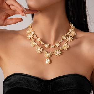 Close-up of double-layer gold necklace with butterfly, pearl flower and water drop crystal