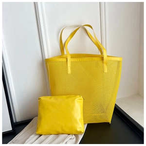 Detail shot of the yellow mesh tote bag and matching PU leather zipper pouch set