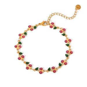 Close-up of pink glitter cherry pendant on 18K gold stainless steel bracelet with adjustable chain