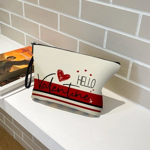 Canvas makeup bag with HELLO Valentine heart print and black handles on white stairs
