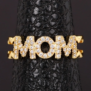 Detailed macro view of gold plated MOM letter ring with pavé cubic zirconia setting