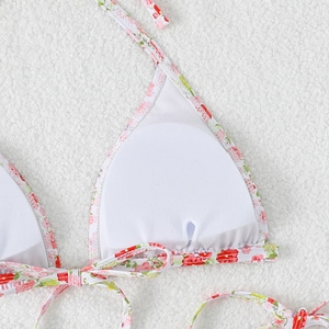 Detail of floral bikini top showing white lining and removable padding pocket