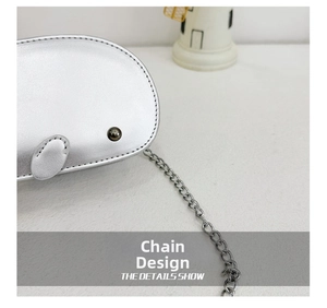 Detail shot of silver leather bag featuring a high-quality dark grey metal chain strap