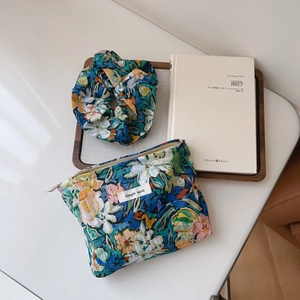 Floral oil painting cotton makeup bag set with a matching hair scrunchie on a wooden tray