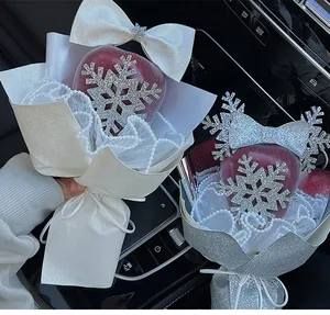 Close-up of Christmas apple bouquet with silver glitter snowflakes and pearl chain