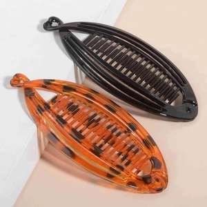 Vertical banana hair clips in glossy black and leopard print for ponytail styling