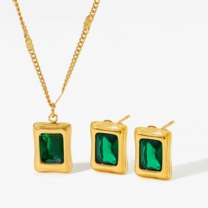 Golden stainless steel jewelry set with rectangular green stones on white background