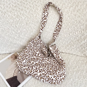 Detail of canvas tote bag with heart-shaped leopard print on soft white fabric