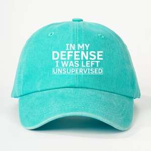 Detailed shot of teal cotton baseball cap with IN MY DEFENSE printed slogan