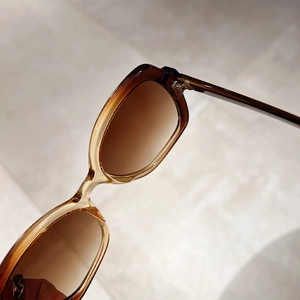 Detail of tortoise shell texture and brown gradient lenses on retro sunglasses