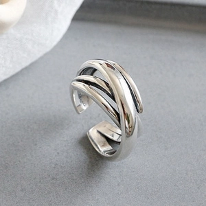 Detailed view of silver multi-layer crossover wrap ring with a minimalist aesthetic