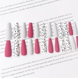 Matte rose pink and leopard print long coffin press-on nails set on a white magazine page