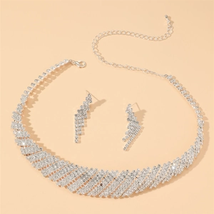 Luxury silver bridal jewelry set featuring a wide rhinestone necklace and drop earrings