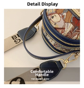 Close-up of jacquard fabric handbag handle with gold-tone hardware and bear patterns
