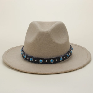 Close-up of khaki fedora hat with ethnic turquoise stones and silver rivets decoration