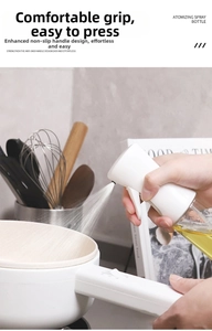 Detailed view of white ergonomic spray head with oil bottle in kitchen setting