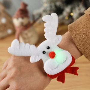 Detail showing plush Christmas reindeer wristband with glowing LED light and red bow