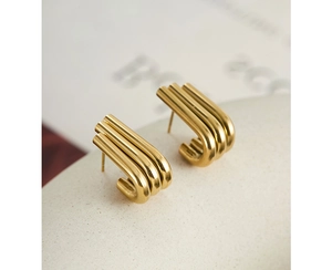 Macro detail of triple-layered U-shaped gold earrings with a polished mirror finish