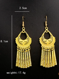 Detail of bohemian gold teardrop earrings with tassels and 8.1cm length dimension
