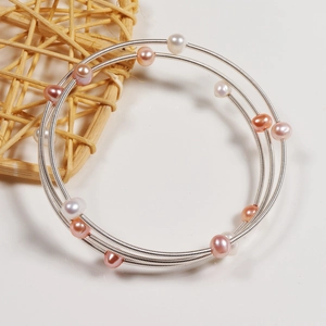 Three-layer freshwater pearl spiral bracelet with white, pink, and purple pearls
