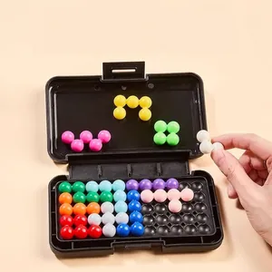 Logic puzzle game with colorful beads in a black box being played by a hand