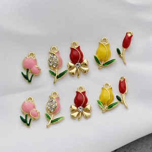 Macro detail of tulip flower pendants with enamel finish and sparkling crystal inlays