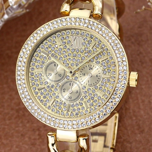 Close-up of gold iced-out watch with crystal-encrusted dial and Roman numeral XII detail