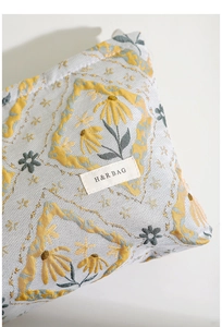 Detailed macro shot of vintage floral jacquard fabric and H&R BAG woven label