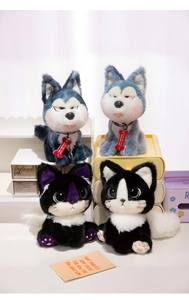 Close-up of plush husky and cat dolls with colorful bone tags and paw pad details