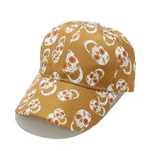 Detail of vintage punk baseball cap in mustard yellow with skull patterns and stitching