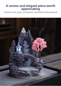 Macro detail of resin backflow incense burner with mountain landscape and misty waterfall effect