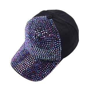 Detail of black baseball cap featuring iridescent rhinestones on front and brim