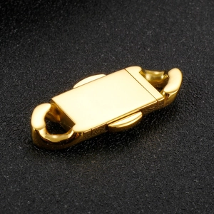 Polished golden stainless steel Cuban chain clasp displayed on dark textured background