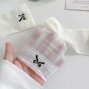 Sheer white ballet-style crew socks with black bow embroidery and ribbed mesh texture