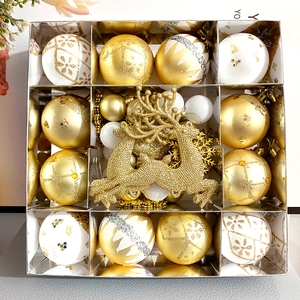 Dettagli di palline di Natale bianche e dorate con renna glitterata in confezione