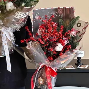 Christmas apple flower bouquet with red berries, dried roses, cotton and pine needles